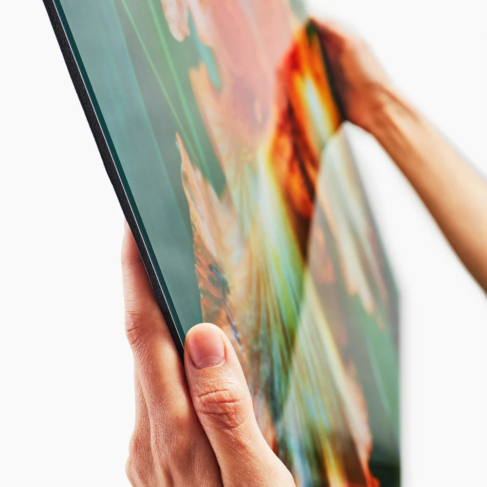 A close-up of a person holding a slim, flexible electronic display or panel with both hands against a clean white background.